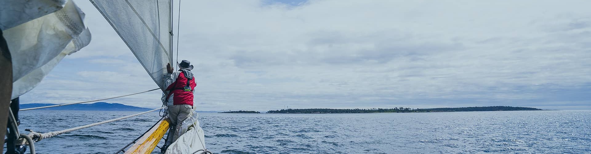 man on helm of ship on ocean